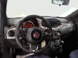 the interior of a small car with a steering wheel and dashboard