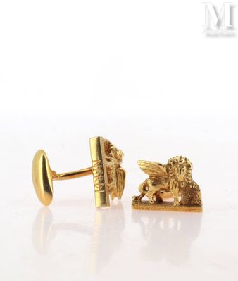 pair of gold tone cufflinks with a lion and a book