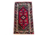 a red and blue rug on a white background
