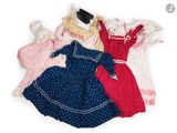 a lot of clothes that are on a white surface