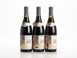 three bottles of wine sitting next to each other on a table
