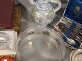 a lot of silver and glass items sitting on a table