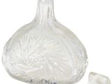 a clear glass bottle with a silver stopper