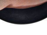 a close up of a person ' s hand holding a black plate with writing on it
