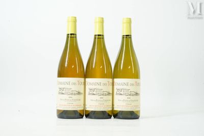 trois bouteilles de vin posées sur une table blanche