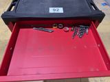 a red tool box that has some screws in it