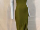 the mannequin is wearing a green dress on a white mannequin mannequin