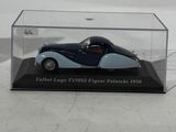 an old model of a blue and white car in a clear case