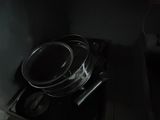 a black stove top with a metal pan on top of it