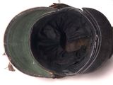 a close up of an old hat with a hole in it