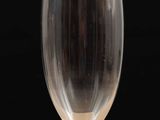 a wine glass sitting on a table with a black background