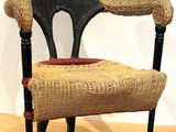 a wicker chair that is sitting on a hard wood floor