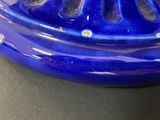 a close up of a blue vase on a table