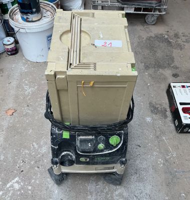 a stack of boxes sitting on top of a cart in a garage