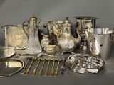 a lot of silver and silverware on a table