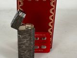 a lighter that is sitting next to a red box
