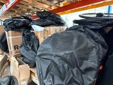 many bags of luggage sitting on a shelf in a warehouse