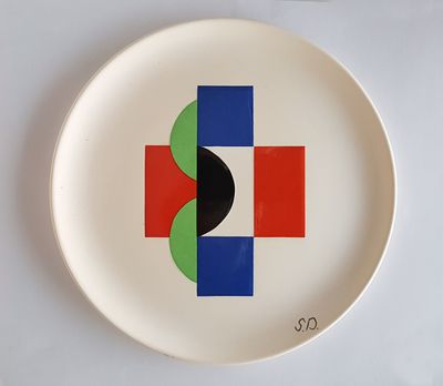 a white plate with a red, blue, and green design on it