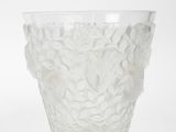 a clear glass vase with a flower design on it
