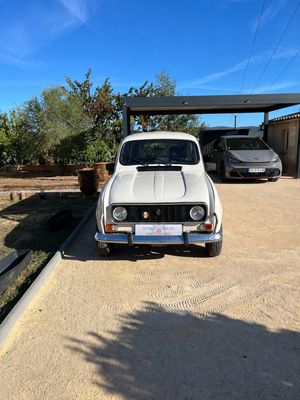 a white car parked in a driveway next to a building
