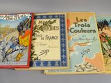three children ' s books are lined up on a table