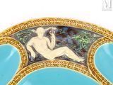 a blue plate with a picture of a nude woman on it