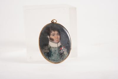 a miniature portrait of a man in a green dress