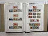 an open book with stamps on it sitting on a table