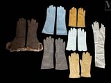 six pairs of gloves are lined up in a row on a black background