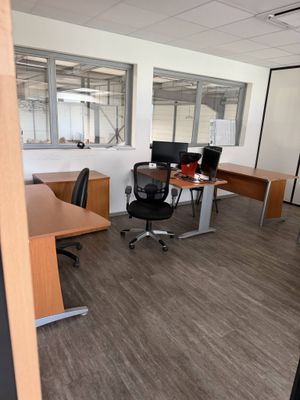 an image of an empty office with a lot of desks