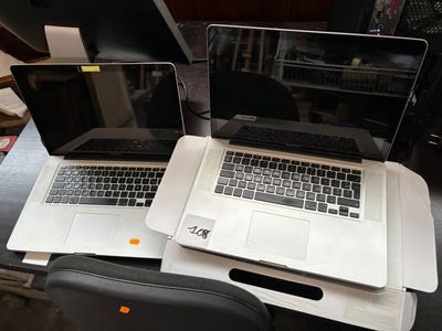 two laptops that are sitting on top of a desk