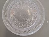 a clear plastic plate with a circular design on it