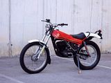 a red and black motorcycle parked in a parking lot