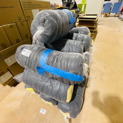 several stuffed animals are stacked on top of each other in a warehouse