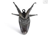 a statue of a horned head with horns on it