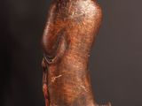 an old wooden statue of a man with a hat on his head