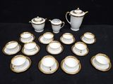 many cups and saucers sitting on a black table