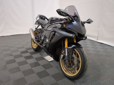 a picture of a black motorcycle parked on a checkered floor