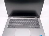 an open laptop computer sitting on top of a white table
