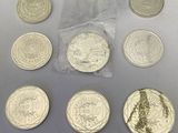 six different coins are shown in a bag on a table