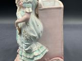 a figurine of a woman holding a child