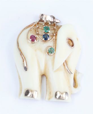 an elephant with a saddle on it ' s back on a white surface