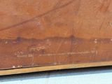 a piece of wood that has been scratched off and is sitting on the ground