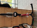 a scooter, a bicycle, and a helmet on a table