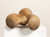 three wooden mushrooms sitting on top of a white box
