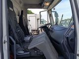 a white truck with the door open and the driver ' s seat down