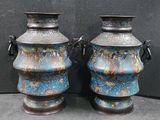 two vases sitting next to each other on a table