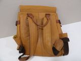 tan leather handbag with brown leather handles on a white surface