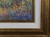 an oil painting of a field of wildflowers in a gold frame