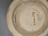 a white plate with a name on it on the wall